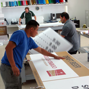 People Working In Sign Shop